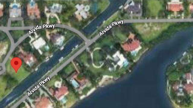 Two men are accused of falsely trying to get a $6 million loan by using a vacant $10 million lot, marked at left, in Gables Estates.